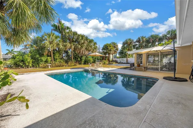 a view of swimming pool with outdoor seating and plants