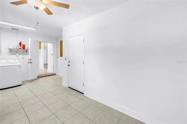 a view of a kitchen with wooden cabinets and white appliances
