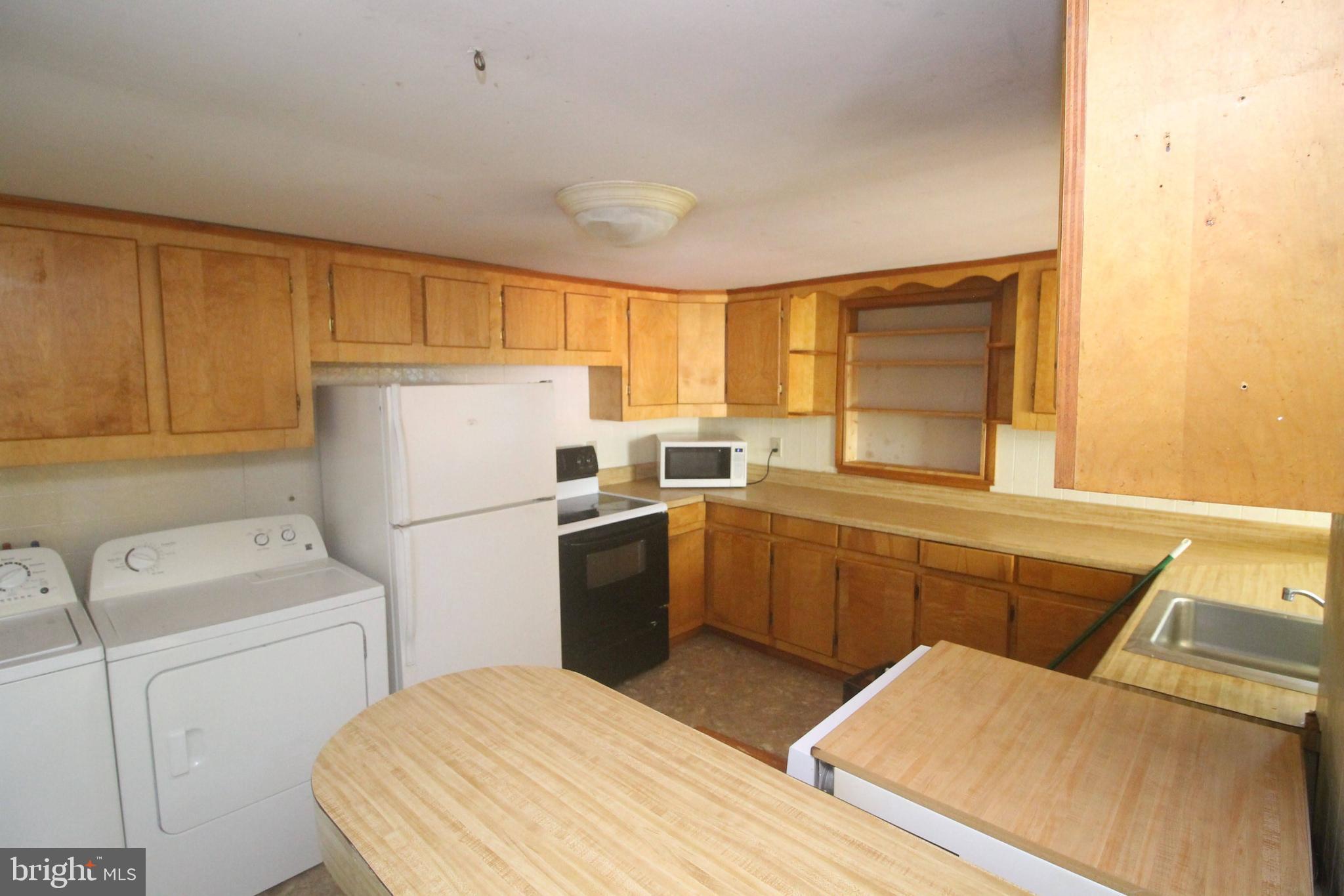 199 Keyser Run Road Washington, VA 22747 - Photo 11 of 30 a kitchen with a refrigerator and a sink