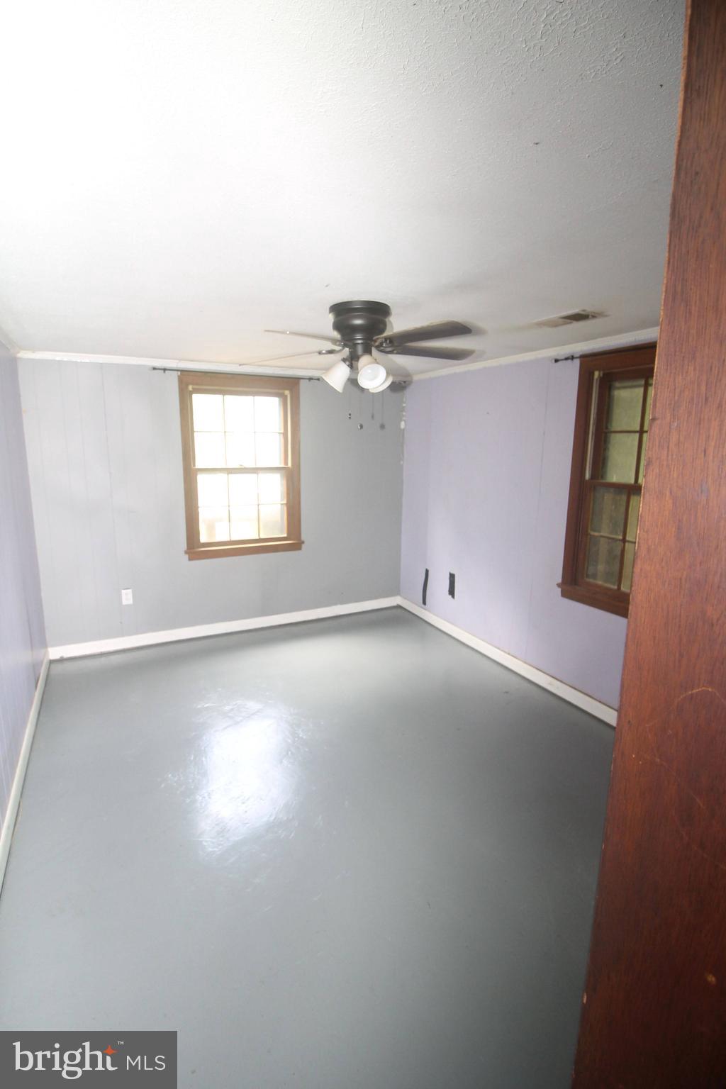 199 Keyser Run Road Washington, VA 22747 - Photo 19 of 30 an empty room with windows and ceiling fan
