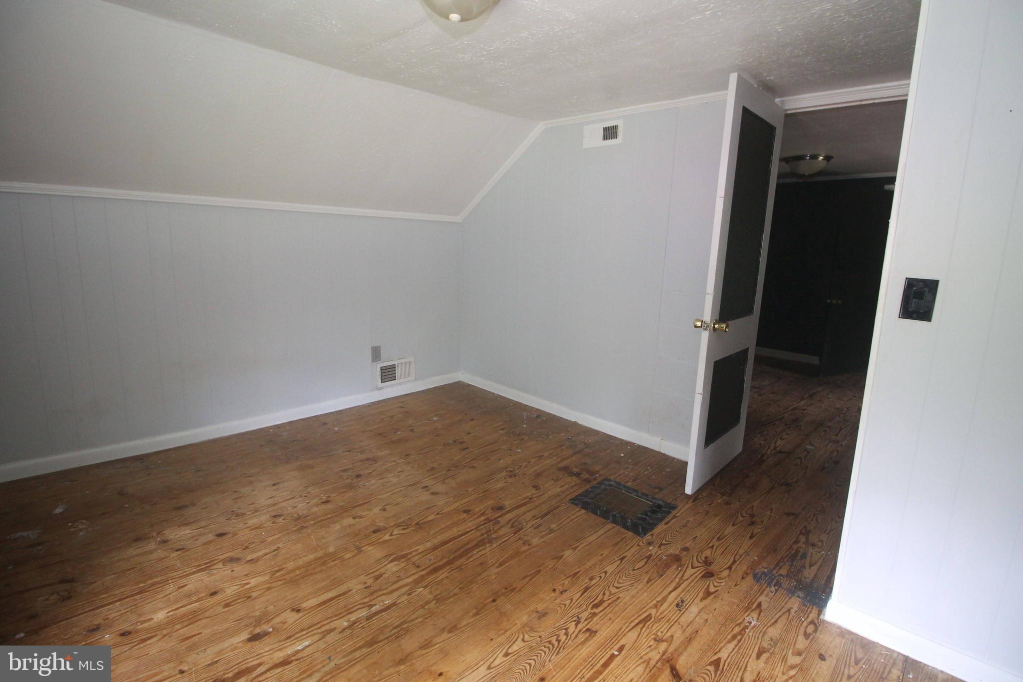 199 Keyser Run Road Washington, VA 22747 - Photo 21 of 30 an empty room with wooden floor and entrance