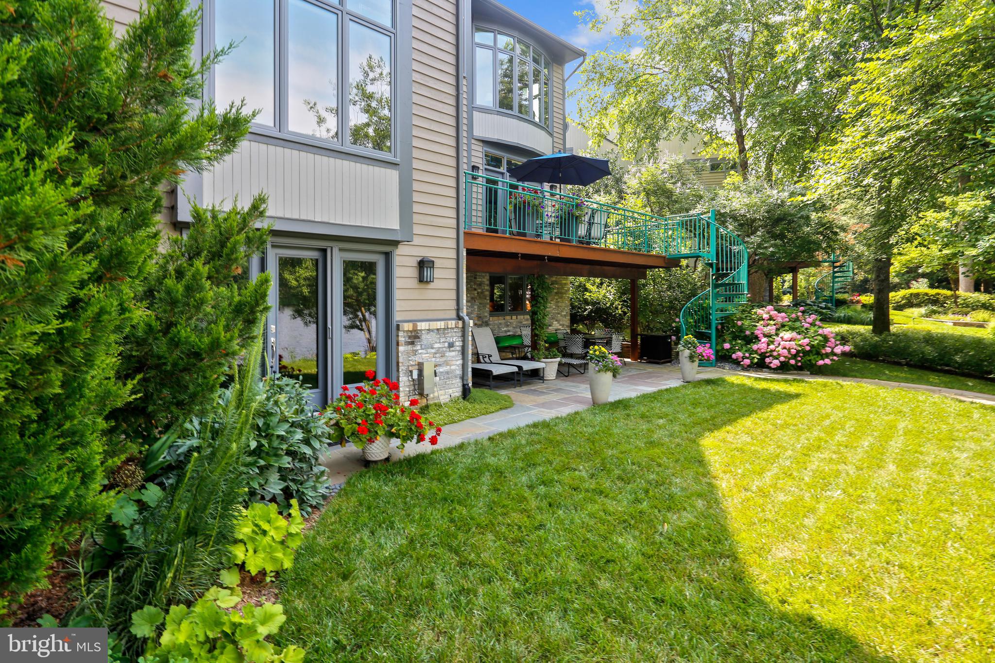 1480 Waterfront Road Reston, VA 20194 - Photo 54 of 65 a view of a swimming pool with lawn chairs and a large tree