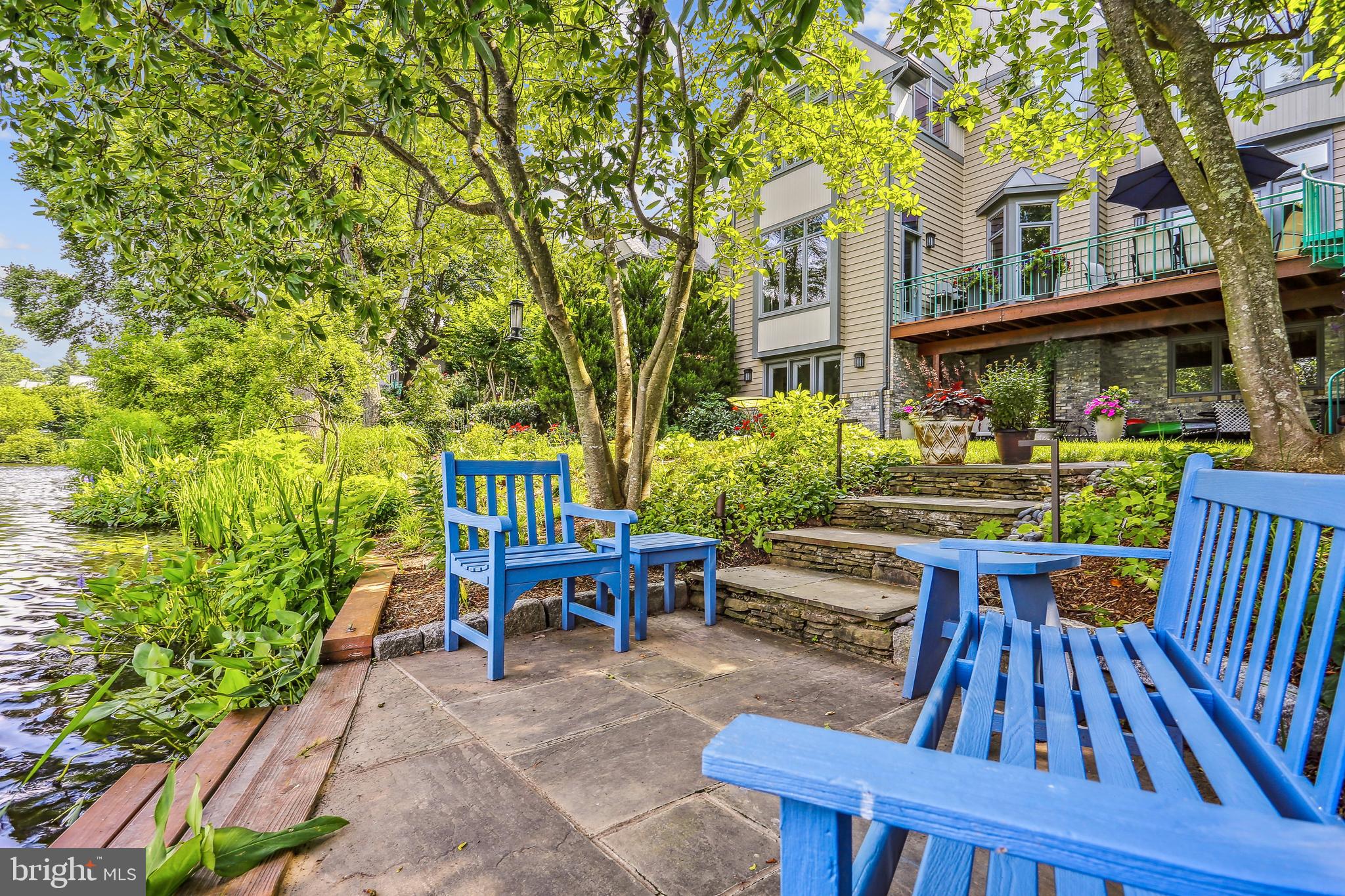 1480 Waterfront Road Reston, VA 20194 - Photo 61 of 65 a view of a patio with table and chairs potted plants and large tree