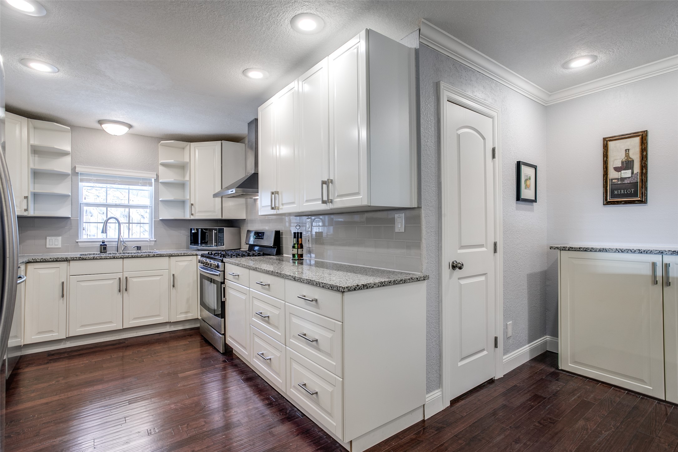 332 Tuttle Road Terrell Hills, TX 78209 - Photo 9 of 25 a kitchen with granite countertop white cabinets and white appliances