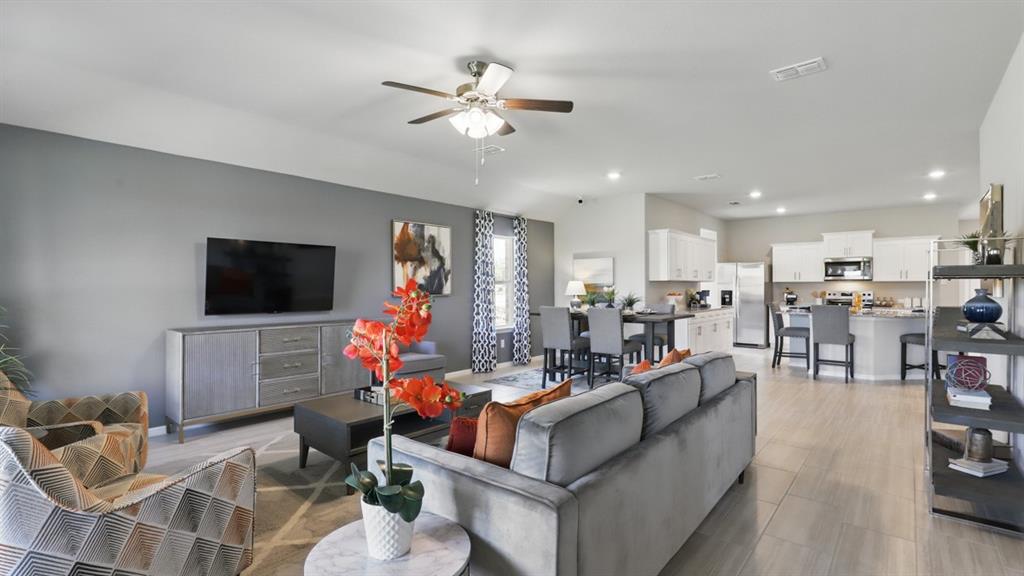 16449 Hudson Pr Way Justin, TX 76247 - Photo 14 of 35 a living room with furniture kitchen view and a flat screen tv