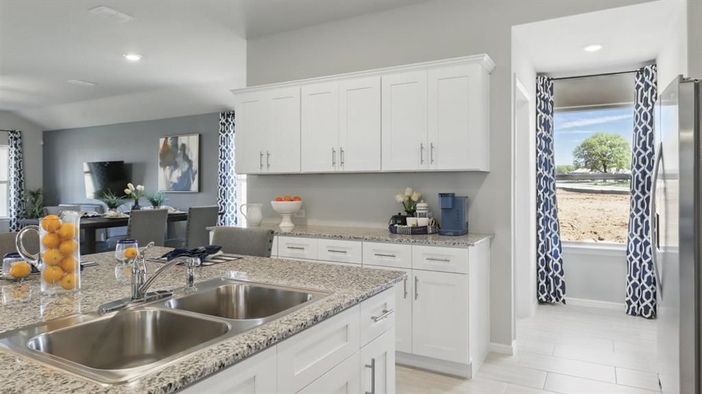 16449 Hudson Pr Way Justin, TX 76247 - Photo 6 of 35 a kitchen with a sink stove and cabinets
