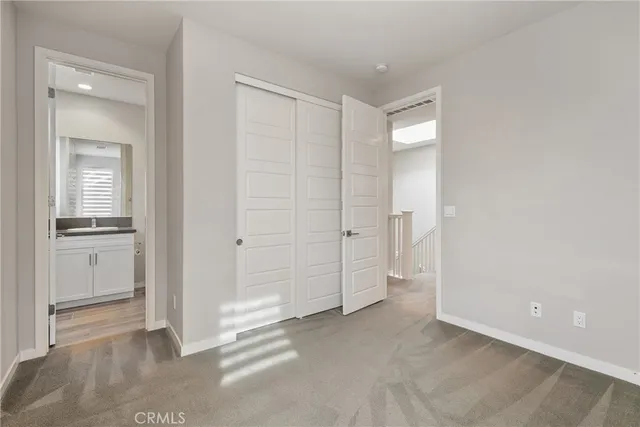 a bathroom with a granite countertop sink toilet a mirror and shower