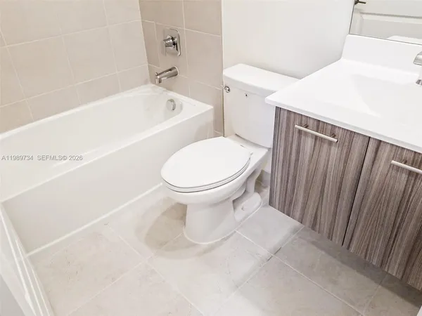 a white toilet sitting next to a bath tub