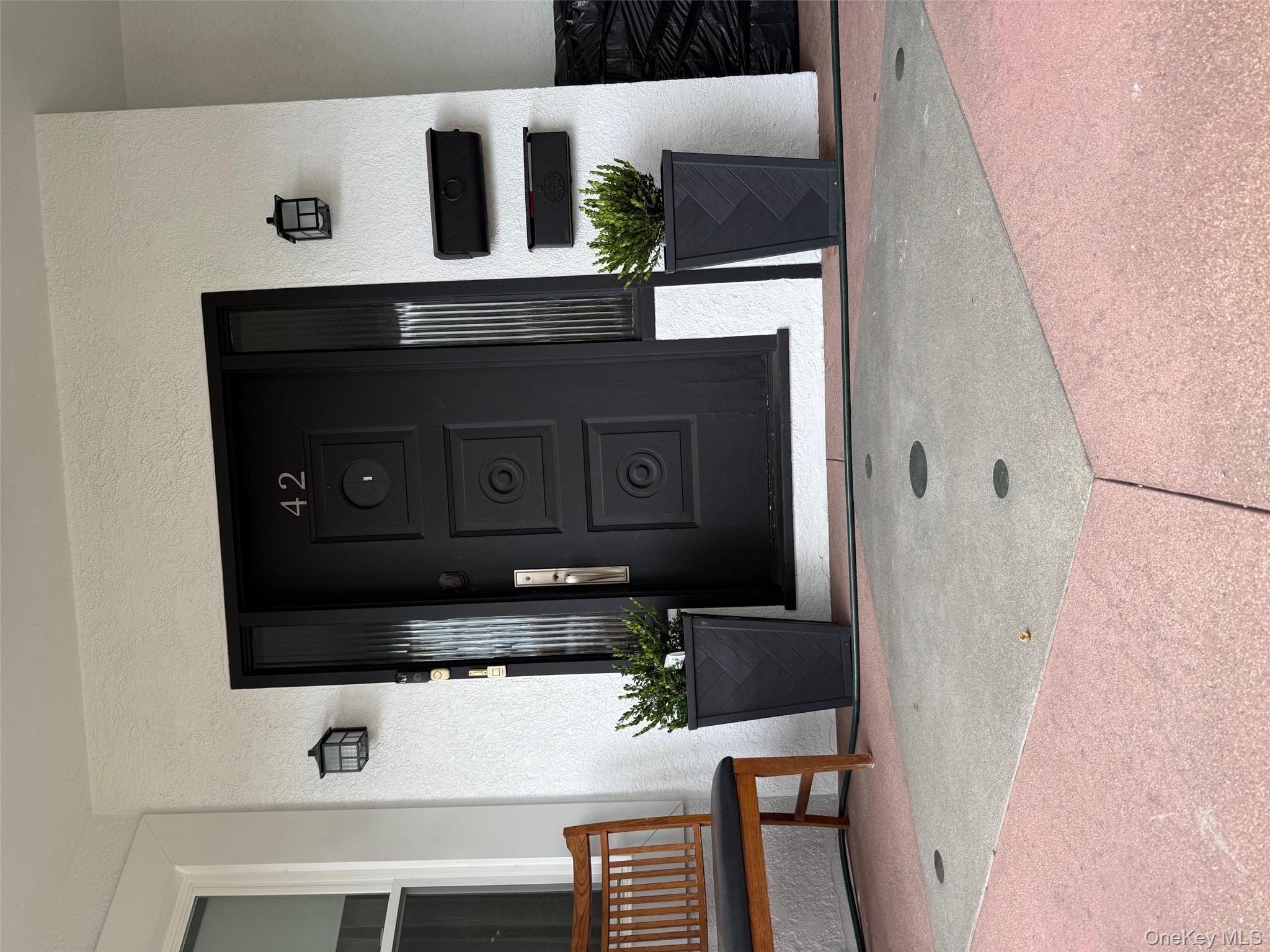 Property entrance featuring stucco siding