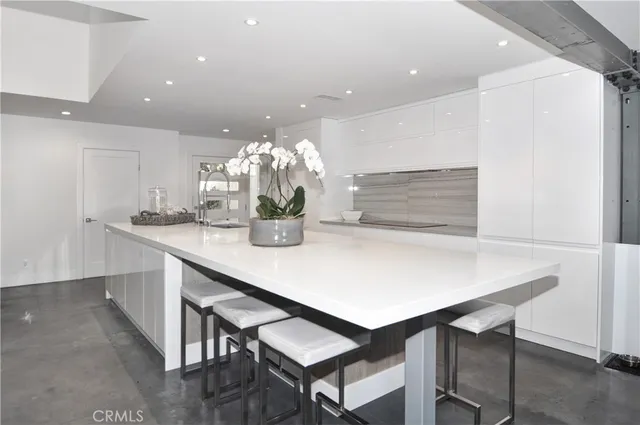 a kitchen with a table and chairs in it