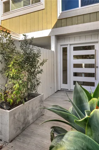 an aerial view of ocean and residential houses with outdoor space