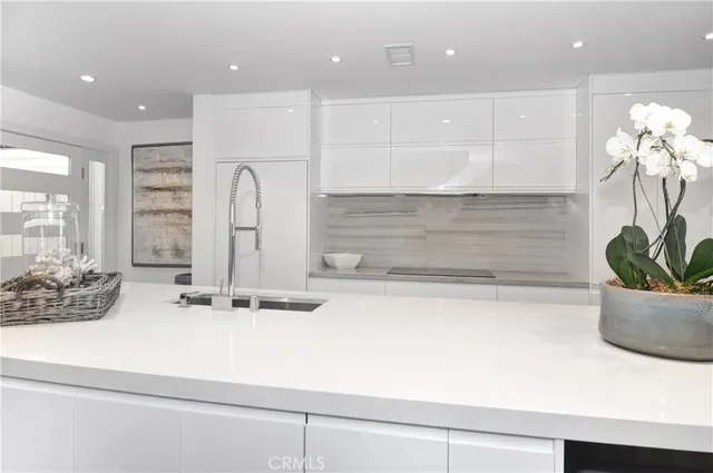 a kitchen with kitchen island a sink stainless steel appliances and cabinets