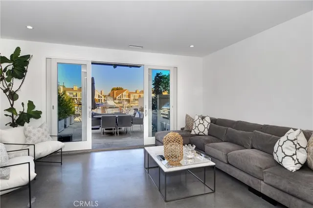 a living room with furniture and a fireplace with garden view