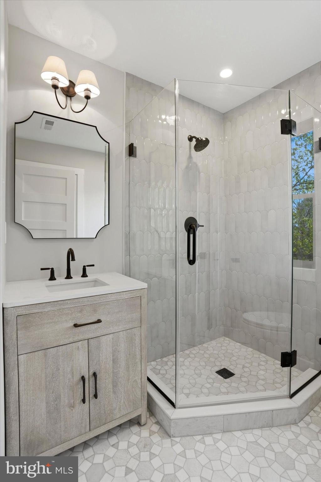 292 Church Road Devon, PA 19333 - Photo 32 of 49 a bathroom with a shower a sink a mirror and a shower