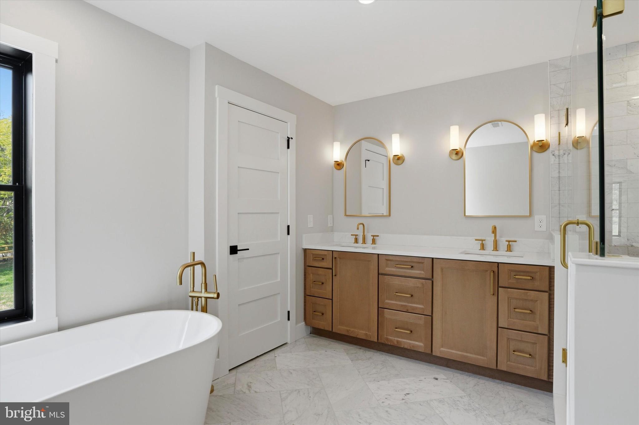 292 Church Road Devon, PA 19333 - Photo 36 of 49 a spacious bathroom with a double vanity sink double mirror and bathtub