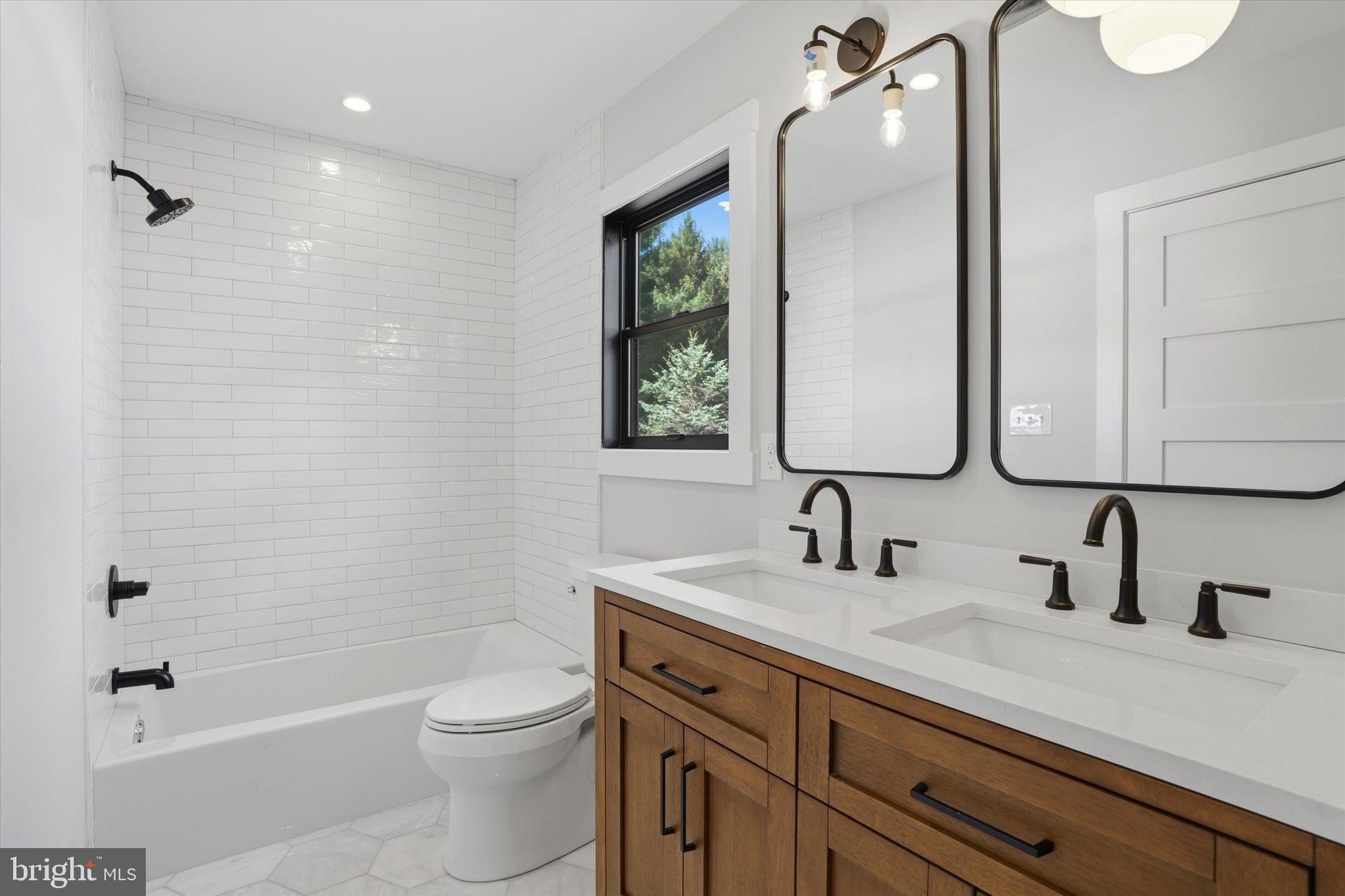 292 Church Road Devon, PA 19333 - Photo 41 of 49 a bathroom with a double vanity sink toilet and shower