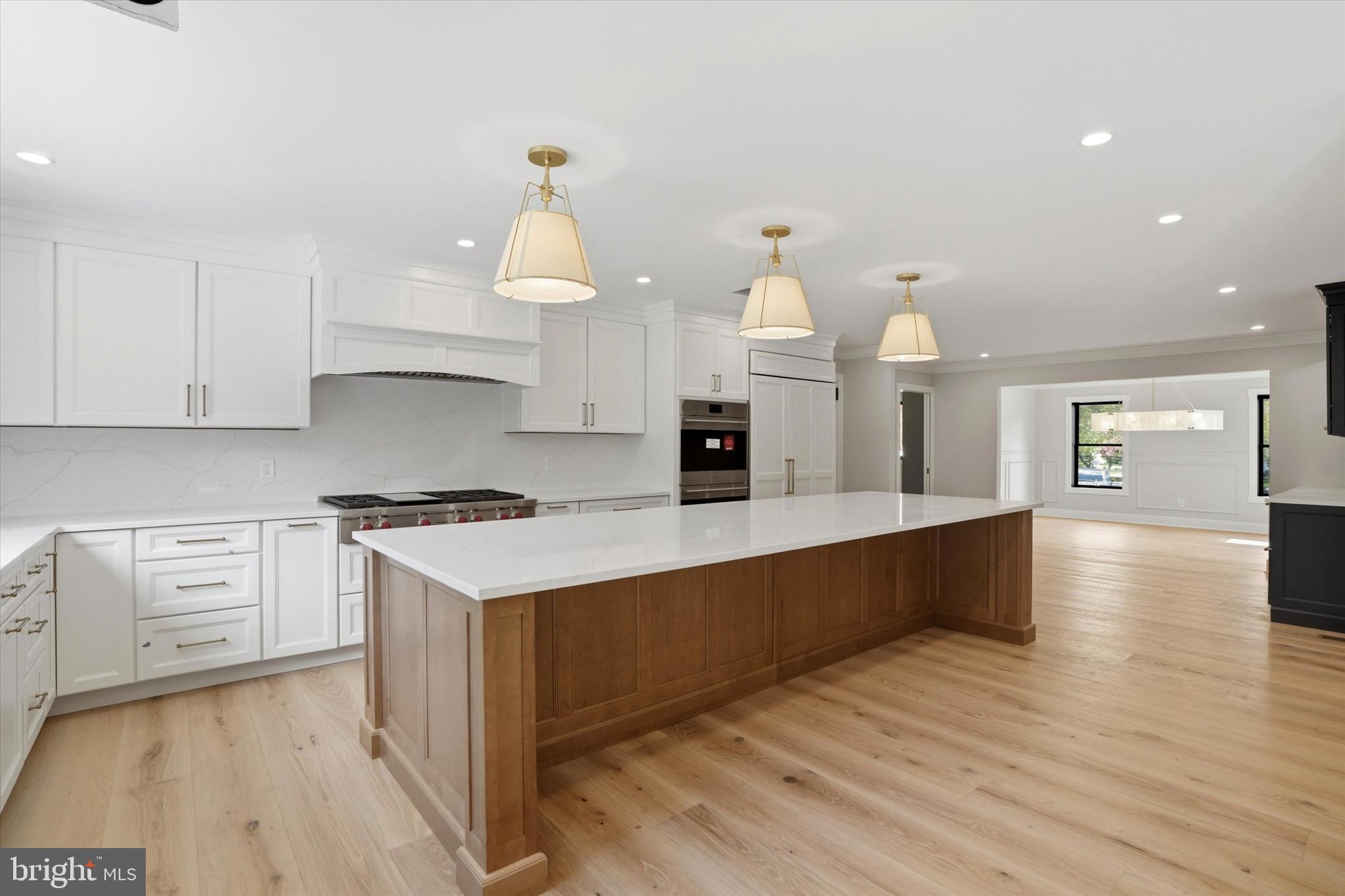 292 Church Road Devon, PA 19333 - Photo 7 of 49 a kitchen with granite countertop a stove and a wooden floors