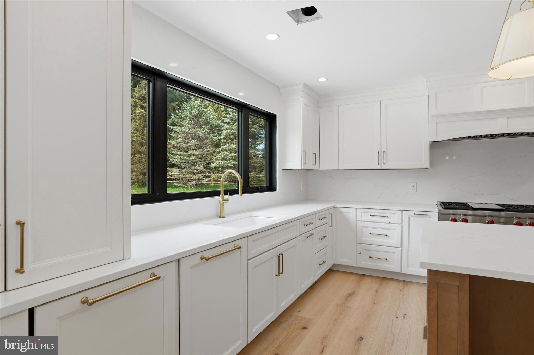 292 Church Road Devon, PA 19333 - Photo 8 of 49 a kitchen with a sink window and cabinets
