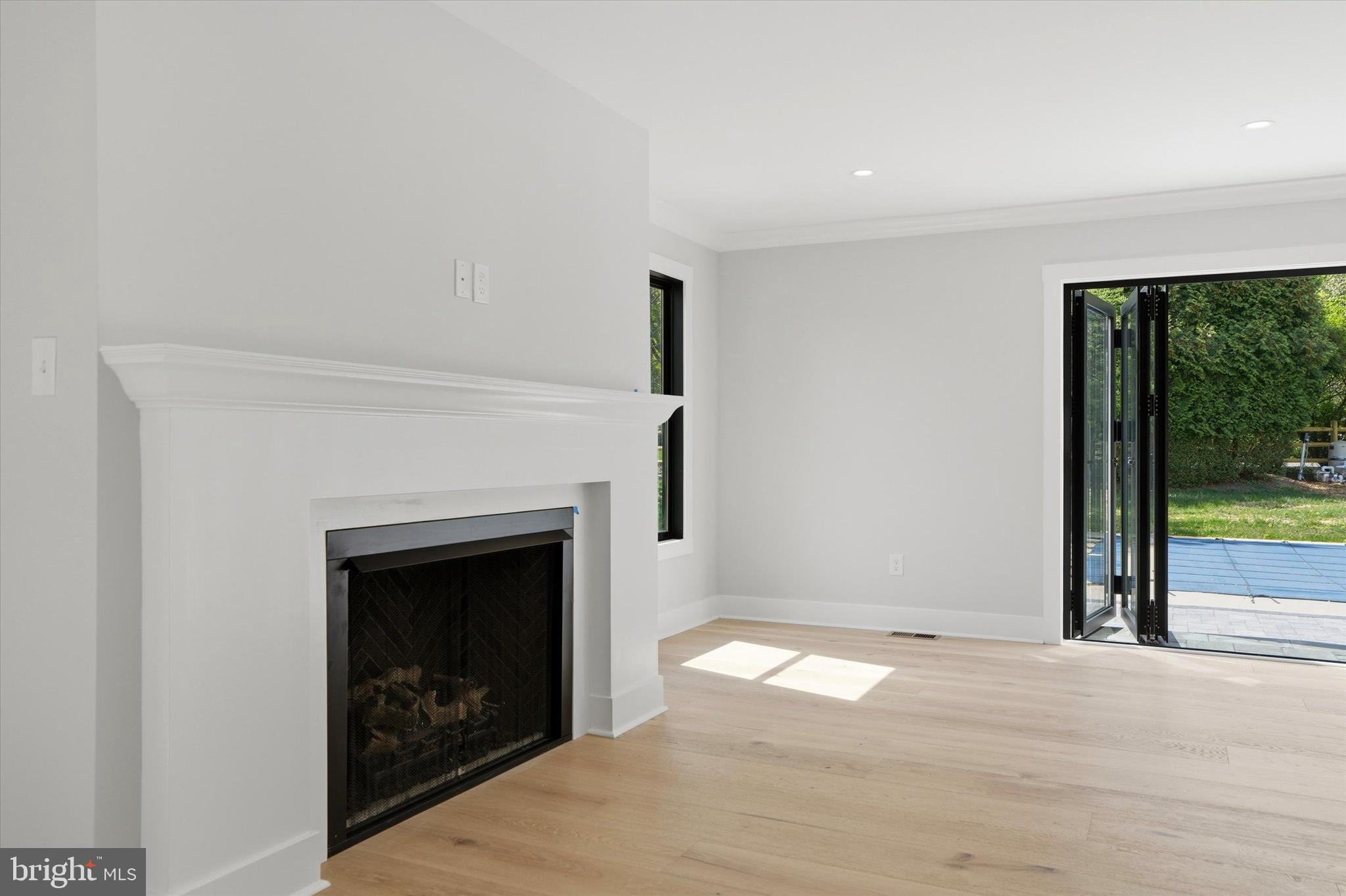 292 Church Road Devon, PA 19333 - Photo 10 of 49 a view of a livingroom with a fireplace and large windows