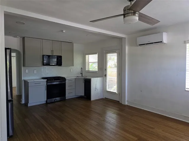 a large kitchen with a refrigerator and a stove top oven
