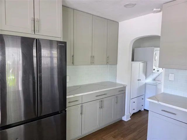 a kitchen with a refrigerator sink and cabinets