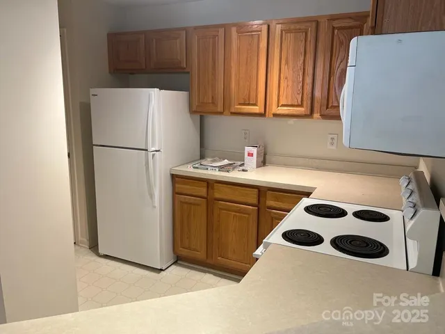 a white refrigerator freezer sitting inside of a kitchen