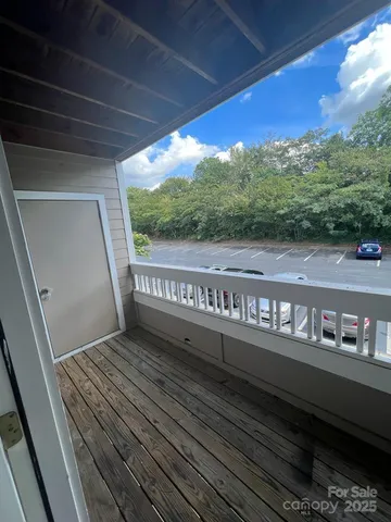 a view of balcony with wooden floor