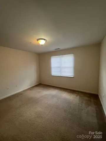 an empty room with a empty space and windows