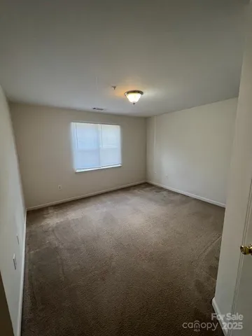 an empty room with a empty space and windows