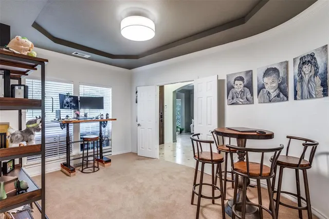 a dining room with furniture and a book shelf