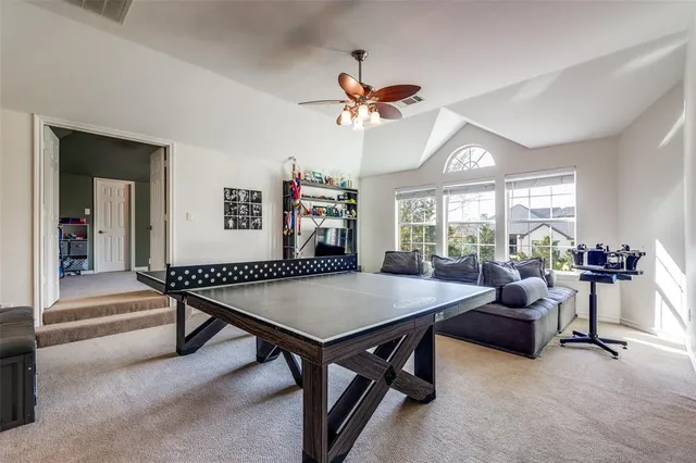 a living room with furniture a table and a large window