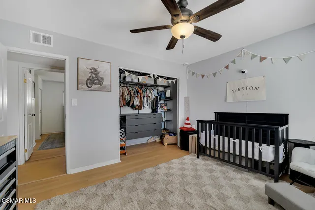 a view of a hallway with workspace and a window