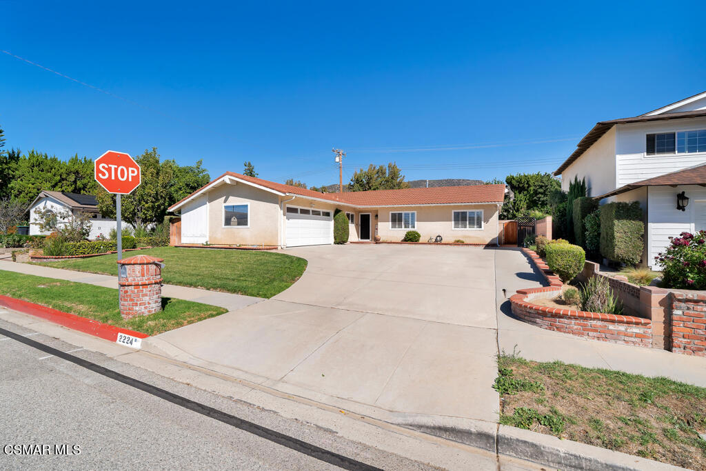 2224 Alscot Avenue Simi Valley, CA 93063 - Photo 30 of 34 a front view of a house with a garden and parking