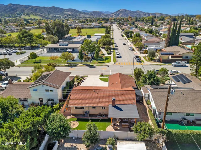 an aerial view of residential houses with outdoor space and street view
