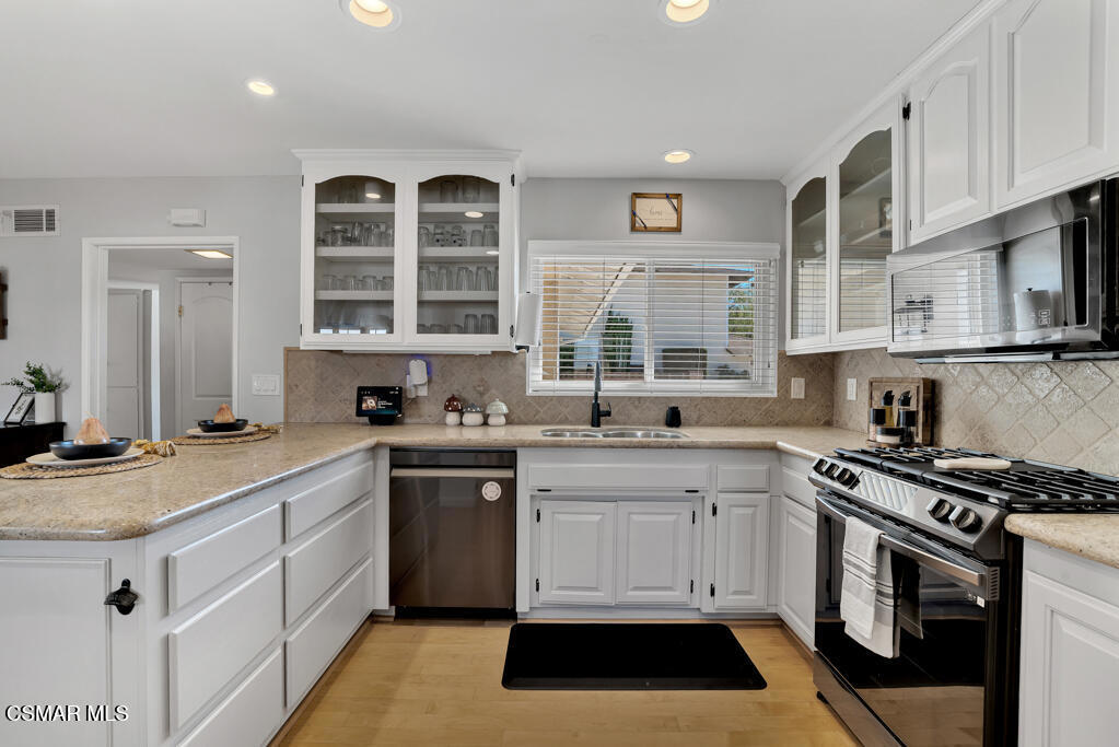 2224 Alscot Avenue Simi Valley, CA 93063 - Photo 4 of 34 a kitchen with stainless steel appliances granite countertop a stove and a sink