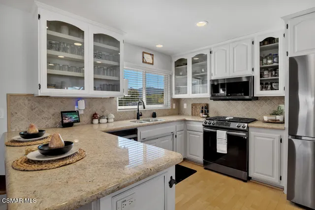 a kitchen with stainless steel appliances granite countertop a stove and a sink