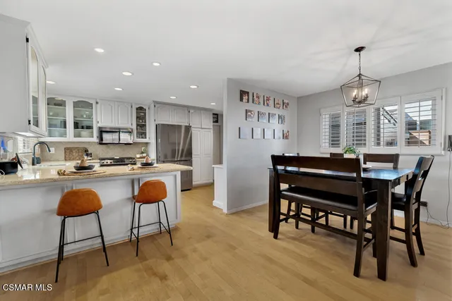 a kitchen with a dining table chairs and kitchen view