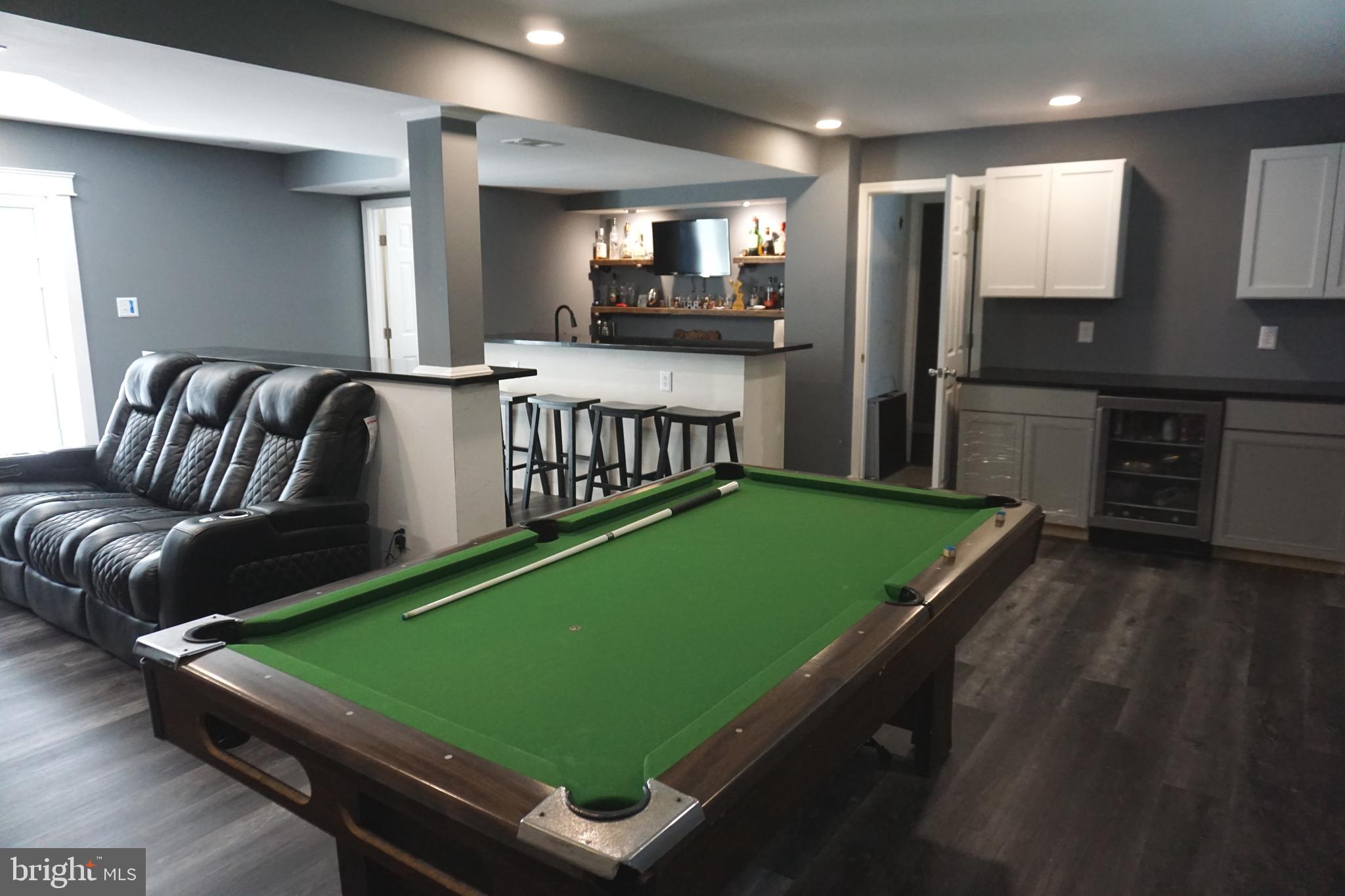 a room with pool table and windows