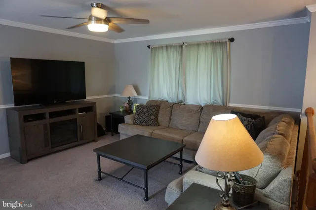 a view of a livingroom with furniture and a window