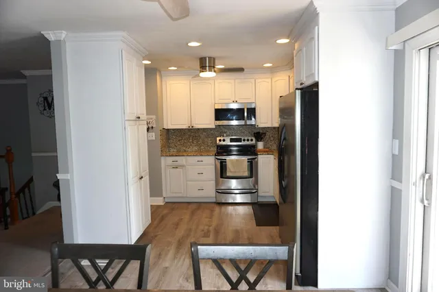a kitchen with granite countertop a sink and a window