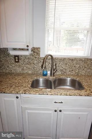 a stove top oven sitting inside of a kitchen
