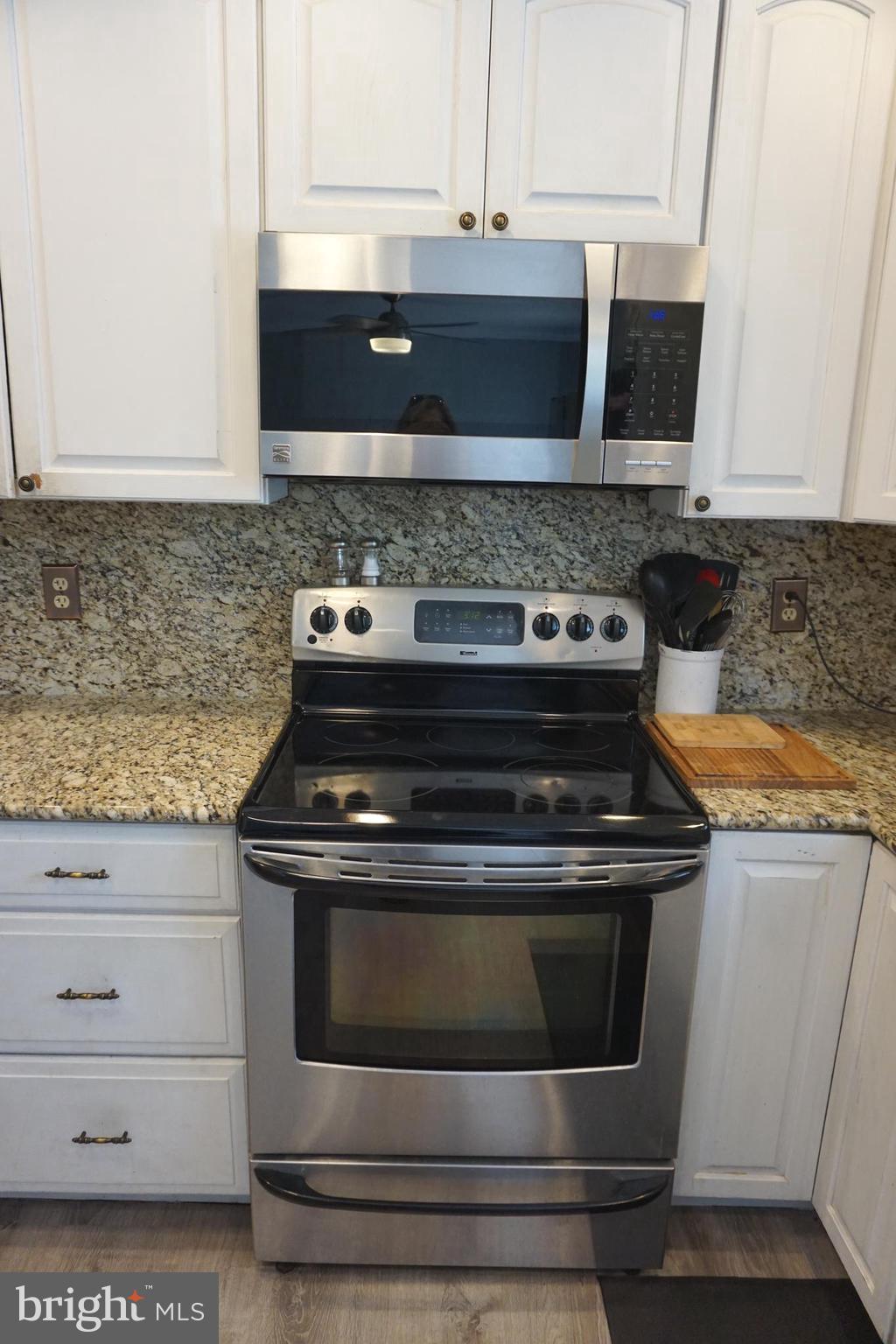 8610 Oak Road Sparrows Point, MD 21219 - Photo 17 of 59 a stove top oven sitting inside of a kitchen