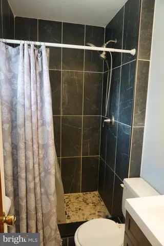 a bedroom with a bed and a flat tv screen on the dresser