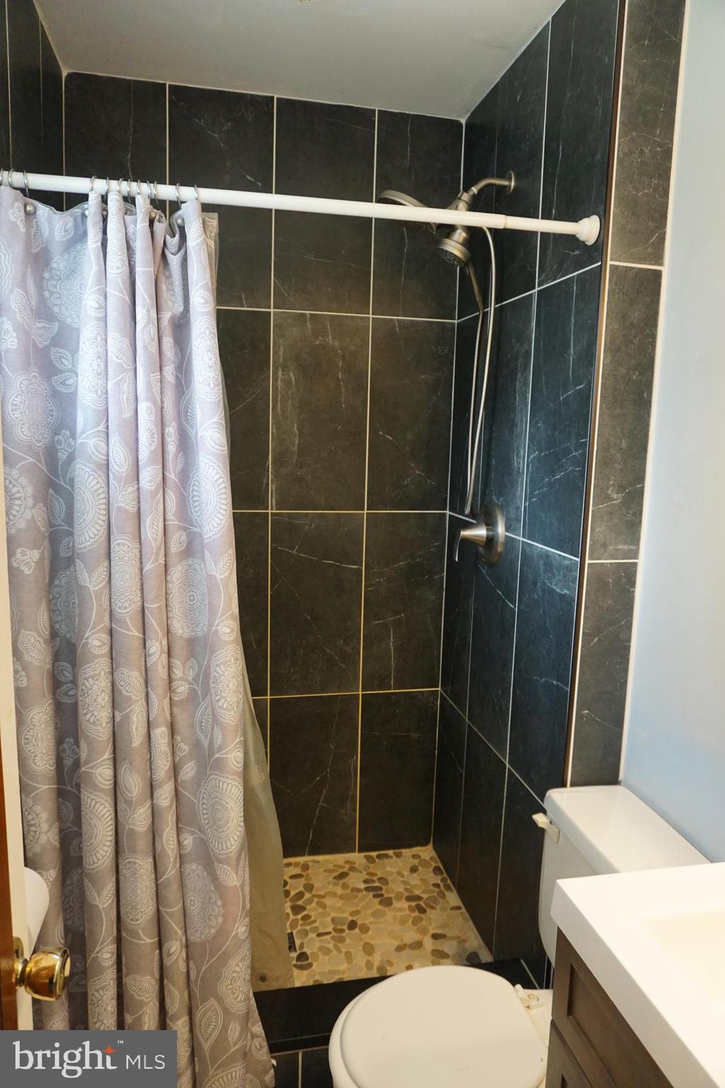 8610 Oak Road Sparrows Point, MD 21219 - Photo 22 of 59 a bathroom with a toilet and a shower