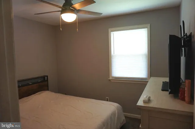 a room with pool table and windows