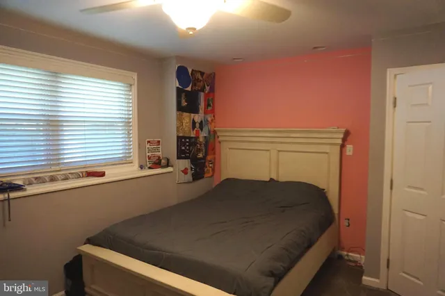 a kitchen with a table chairs refrigerator and microwave