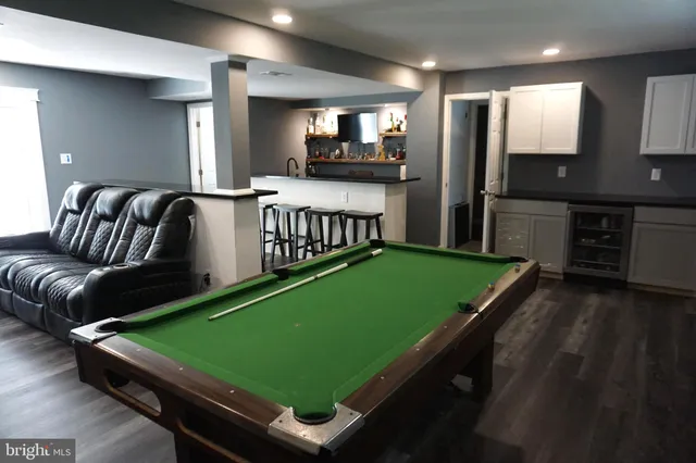 a room with pool table and windows