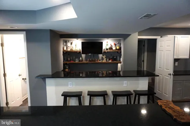 a room with wooden floor and windows