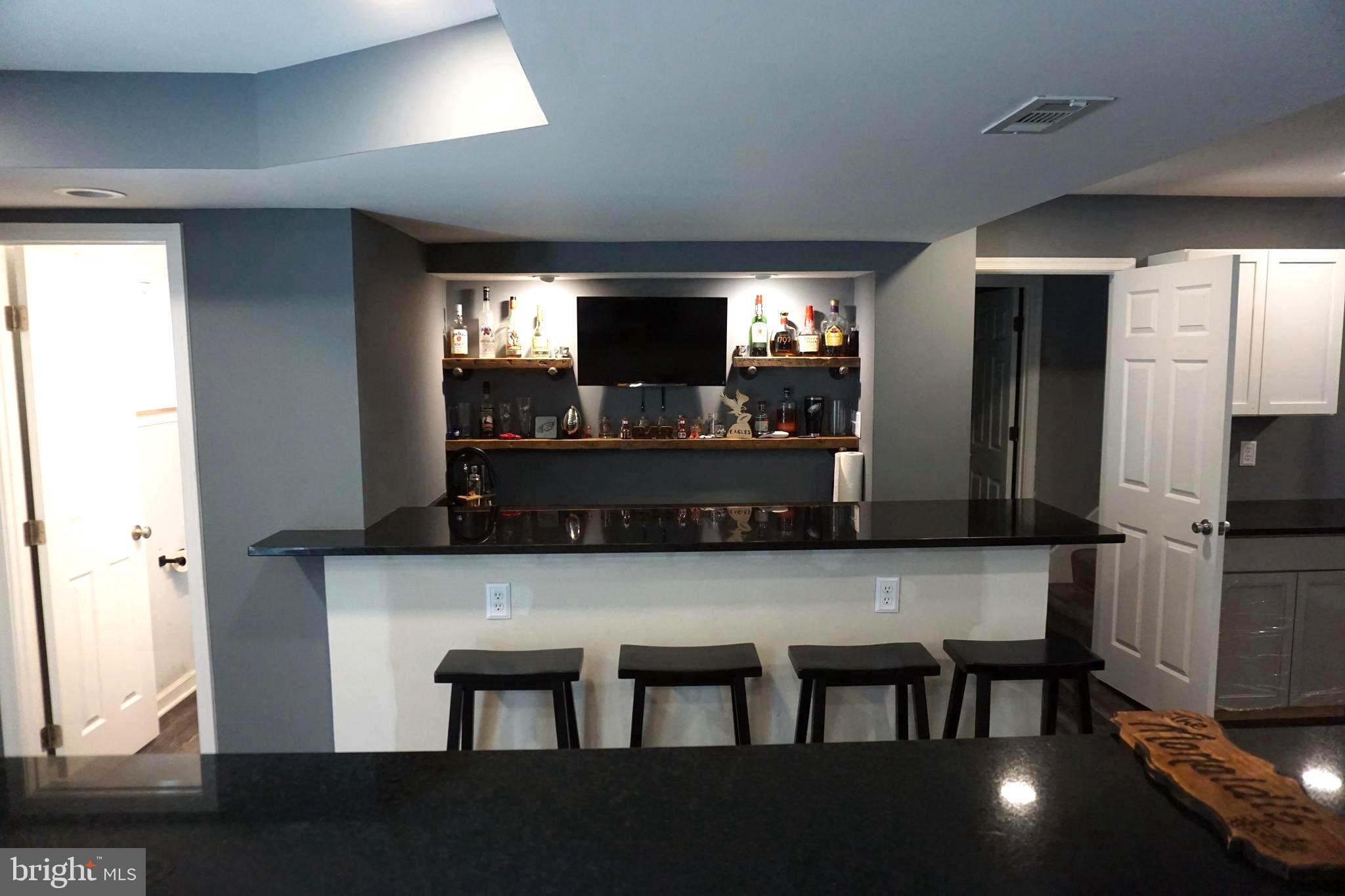 8610 Oak Road Sparrows Point, MD 21219 - Photo 29 of 59 a kitchen with a table chairs refrigerator and microwave