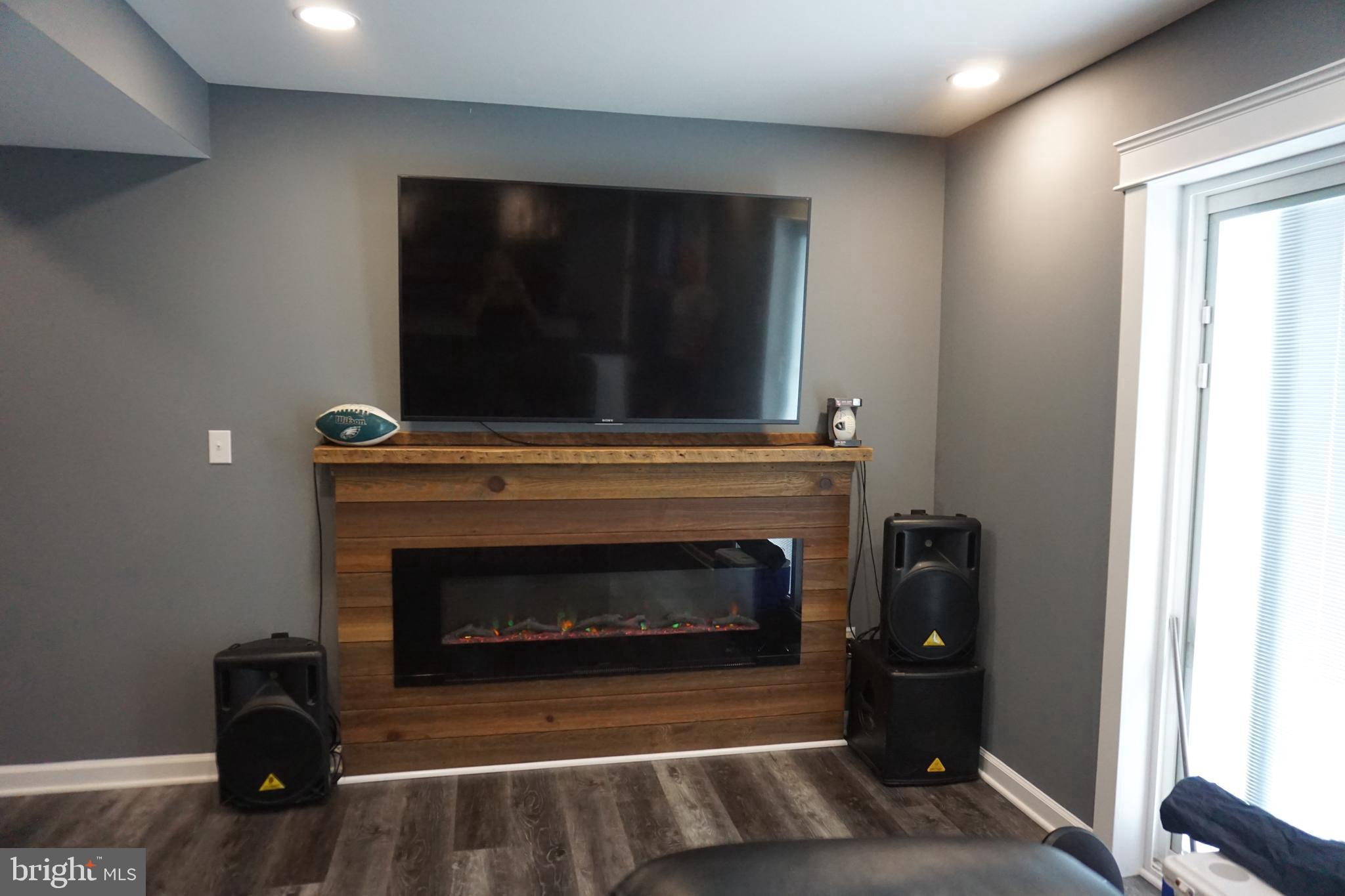 8610 Oak Road Sparrows Point, MD 21219 - Photo 30 of 59 a living room with a fireplace and a flat screen tv